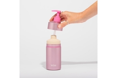 A hand putting the cap on Wild's refillable body wash.